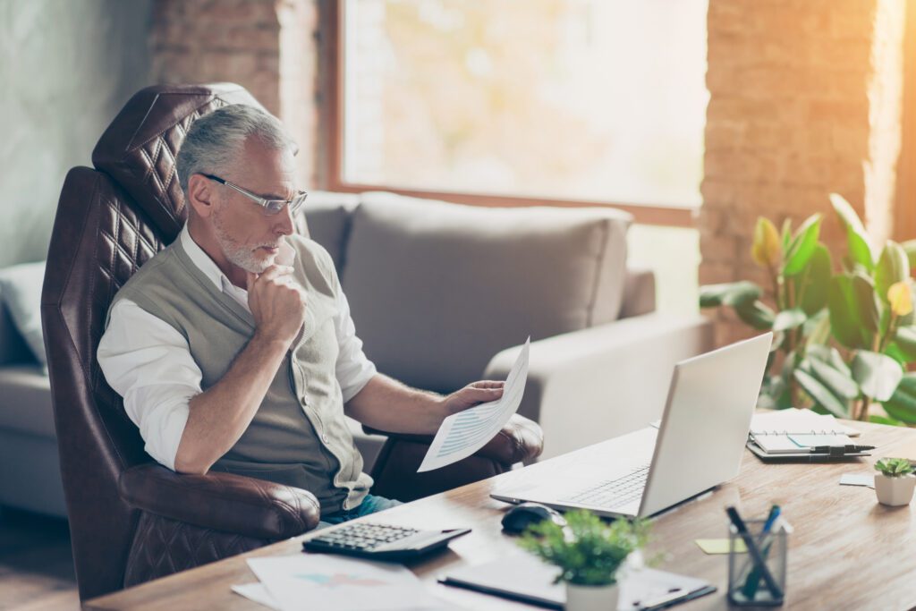 A business owner reading and contemplating using AI for his business