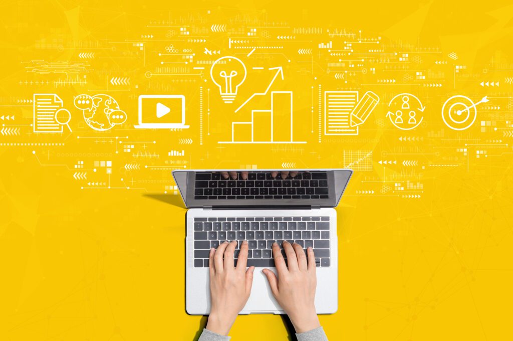 Steel Blue Media Laptop against a yellow background. What is SEO and Why Do I Need It?